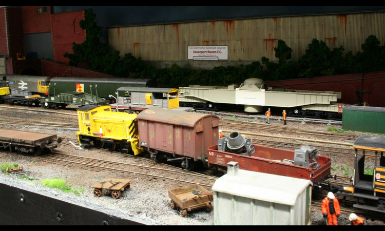 PWM Shunter 97652 on a short departmental train, whilst an MOD nuclear flask train exits the dockyard.